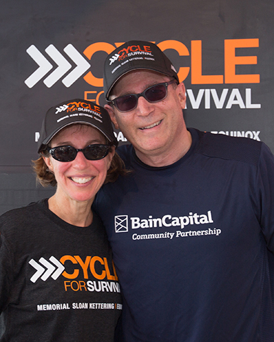 Jeannie and Jonathan Lavine standing together wearing Cycle for Survival hats.