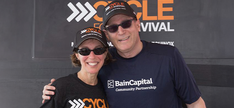 Jeannie and Jonathan Lavine standing together wearing Cycle for Survival hats.