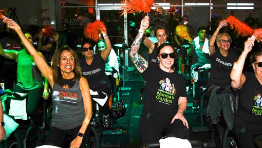 People on stationary bikes at a Cycle for Survival rare cancer fundraising event in Long Island, New York.