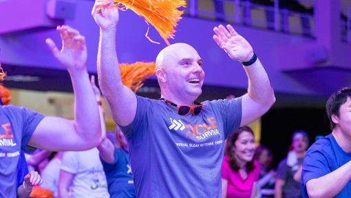 People riding stationary bikes at a Cycle for Survival rare cancer fundraising event in New York City.