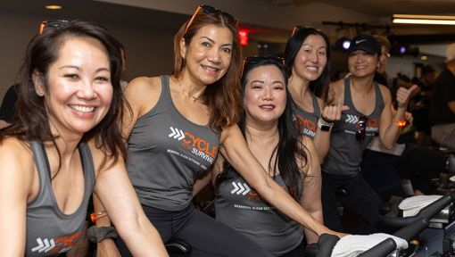 People riding stationary bikes at a Cycle for Survival rare cancer fundraising event in San Francisco.