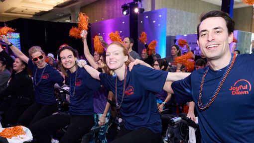 People riding stationary bikes at a Cycle for Survival rare cancer fundraising event in Westchester, New York.