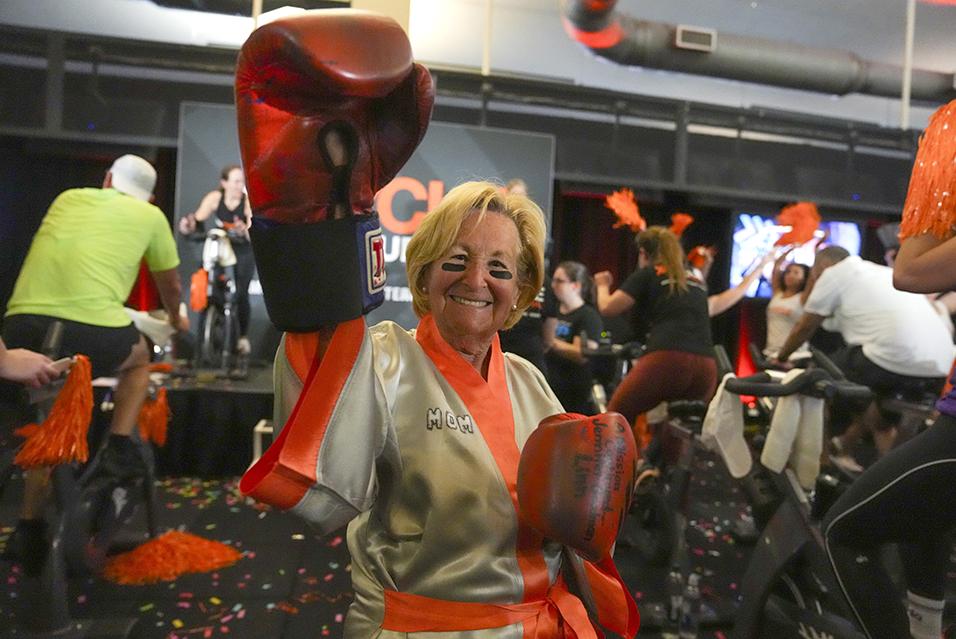 A person wearing boxing gloves at a Cycle for Survival rare cancer fundraising event in Miami. 