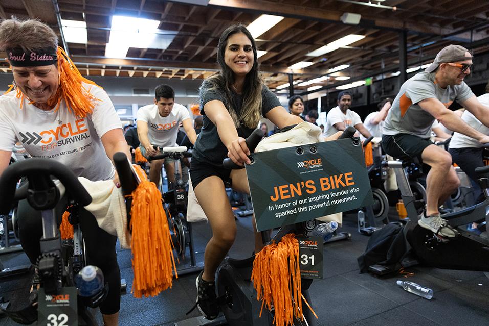 People on stationary bikes at a Cycle for Survival rare cancer fundraising event in Palo Alto.  