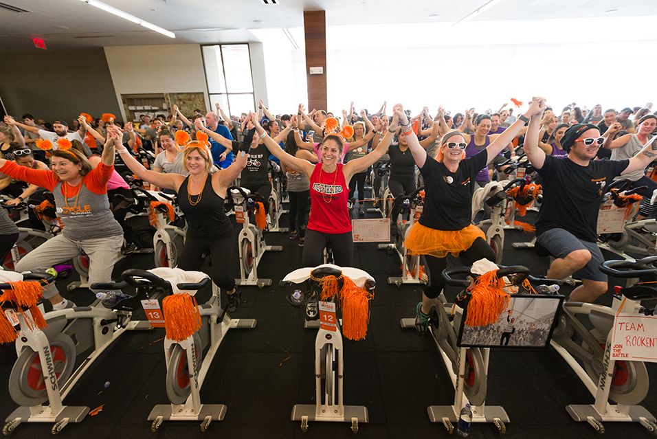 People on stationary bikes at a Cycle for Survival rare cancer fundraising event in Paramus.  