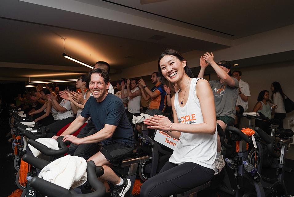 People on stationary bikes at a Cycle for Survival rare cancer fundraising event in San Francisco.  