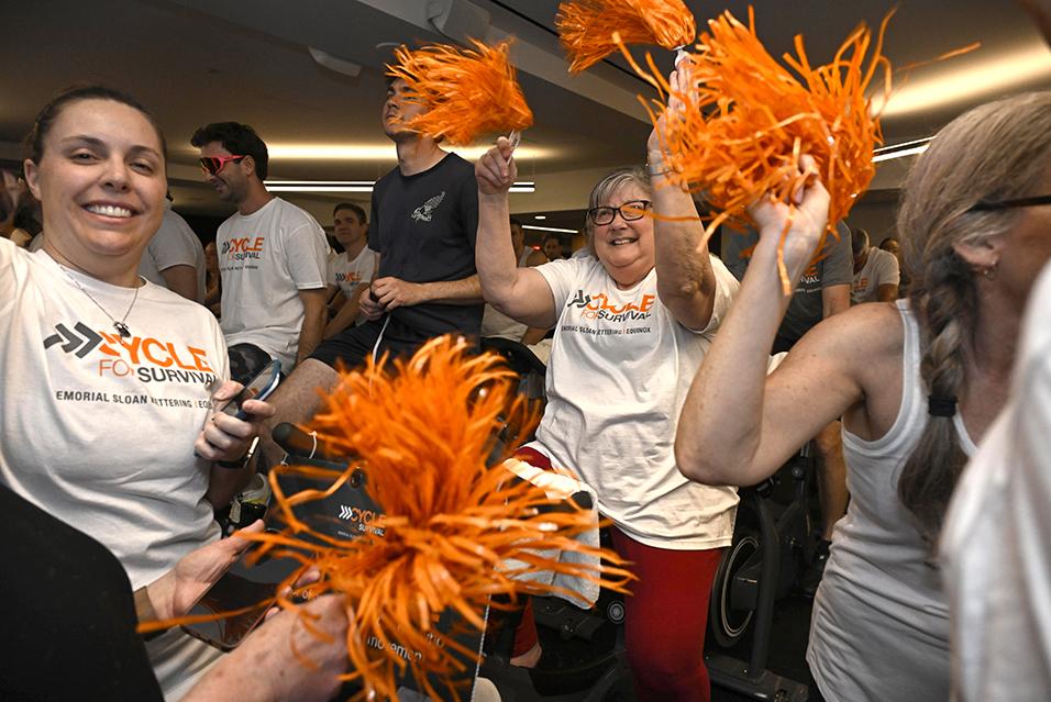 People on stationary bikes at a Cycle for Survival rare cancer fundraising event in San Francisco.  
