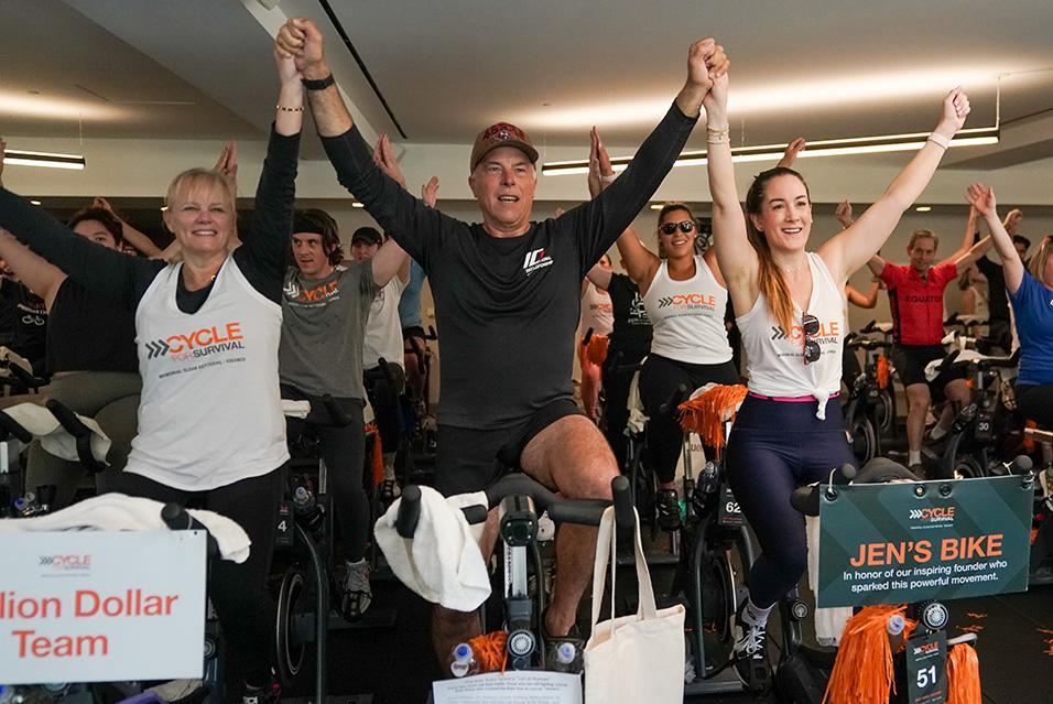 People on stationary bikes at a Cycle for Survival rare cancer fundraising event in San Francisco.  