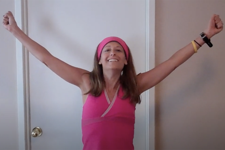 Cycle for Survival founder Jennifer Goodman Linn, raising her arms and smiling while dancing. 