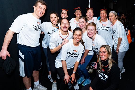 Group of smiling people wearing matching "Shannon Strong" shirts.